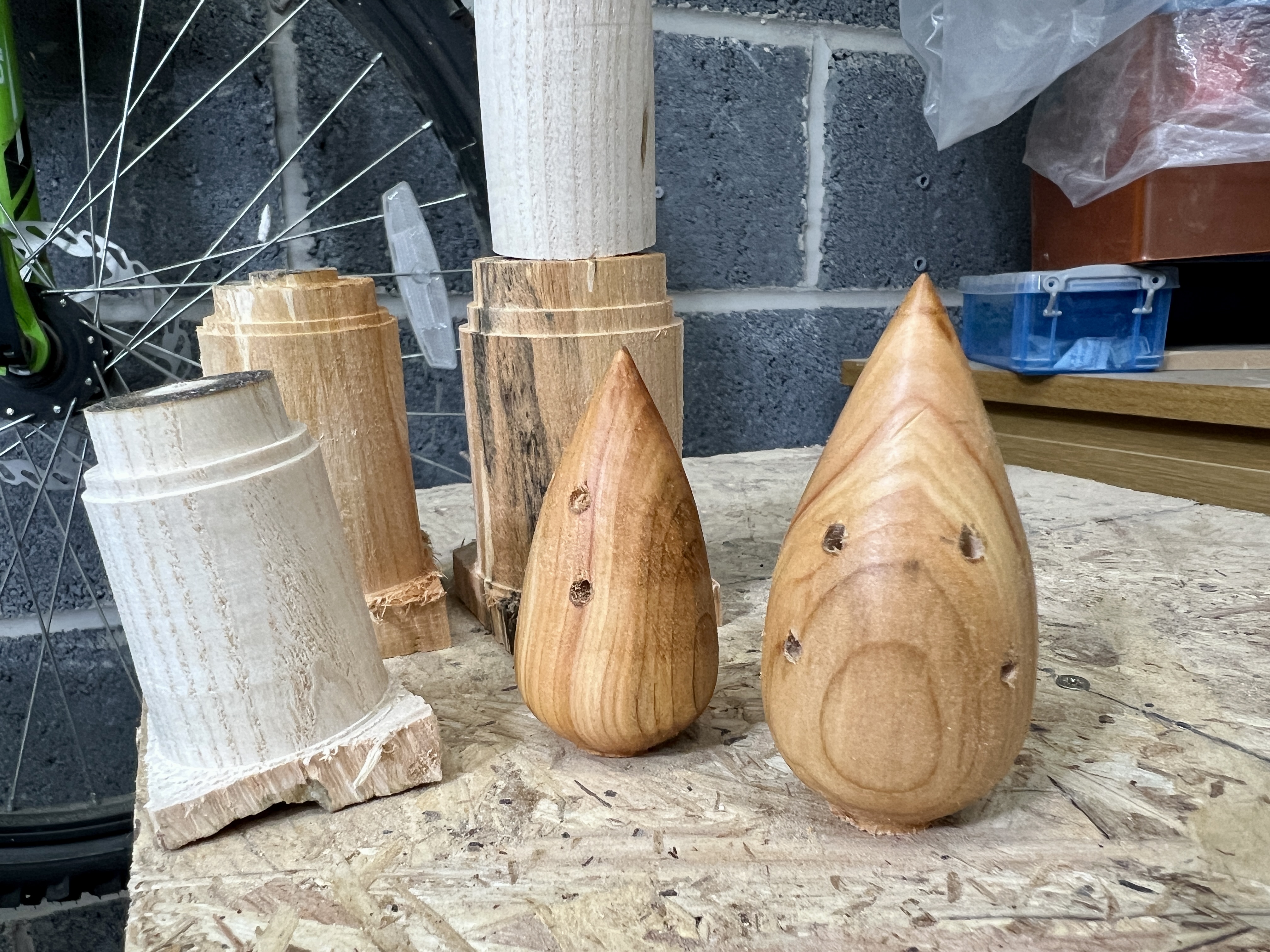 A rough wooden blank being turned into a mouse-shaped body on the lathe